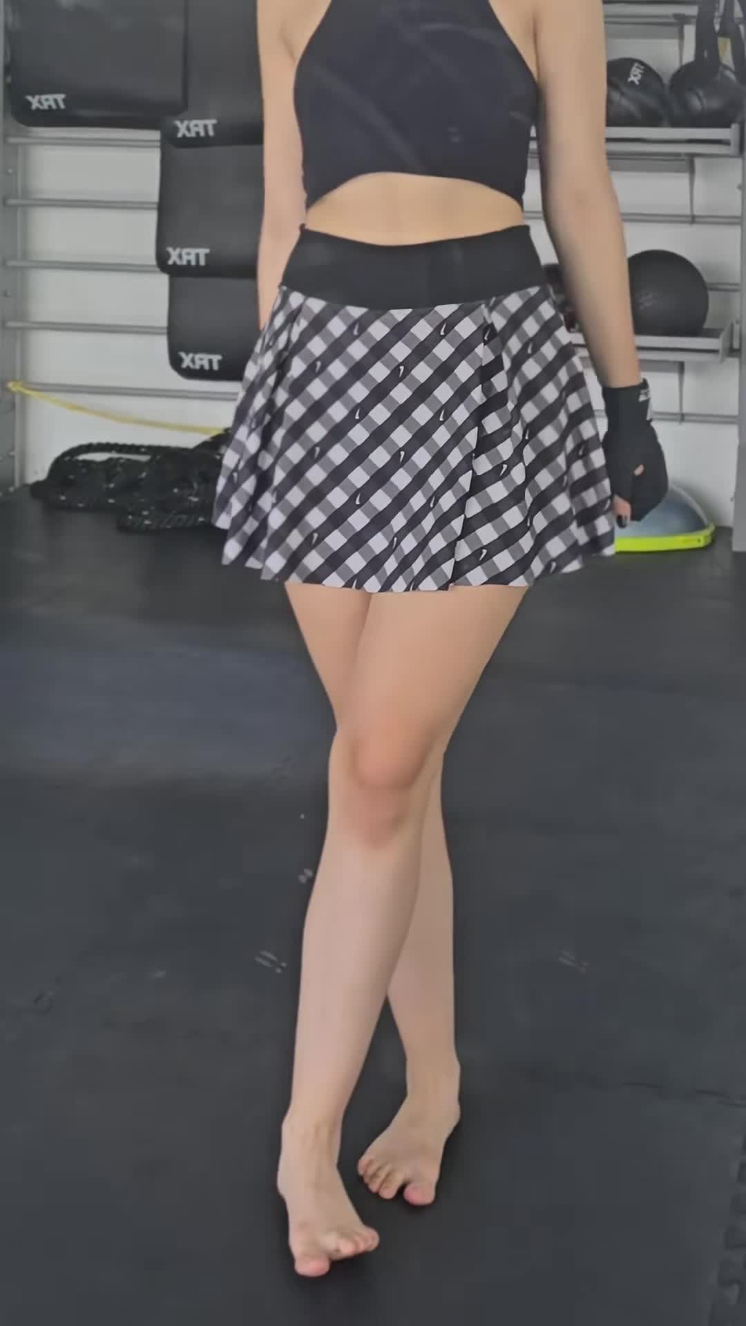Nat The — Black Top, Black And White Checkered Skirt In Gym thumbnail